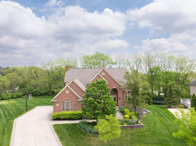 24160 Argyle St, Novi, MI 48374 - view of front of house with brick siding, driveway, a front yard, and a chimney