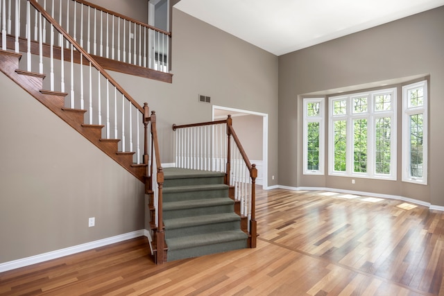 24160 Argyle St, Novi, MI 48374 - staircase with wood finished floors, baseboards, and a towering ceiling