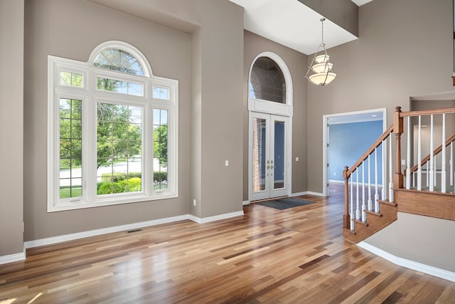 24160 Argyle St, Novi, MI 48374 - foyer entrance with a high ceiling, wood finished floors, baseboards, and stairs
