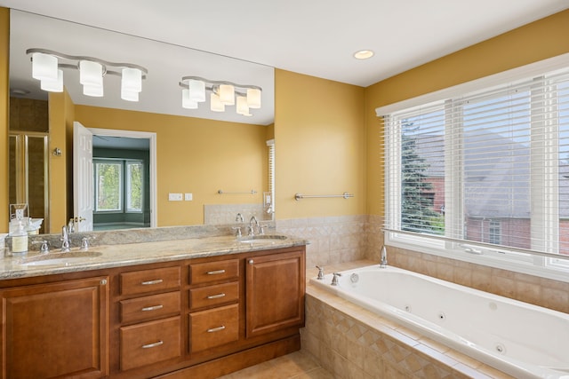 24160 Argyle St, Novi, MI 48374 - bathroom with a whirlpool tub, double vanity, tile patterned floors, and a stall shower