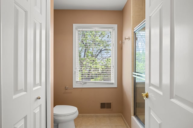 24160 Argyle St, Novi, MI 48374 - bathroom with a shower with door, tile patterned floors, toilet, and baseboards