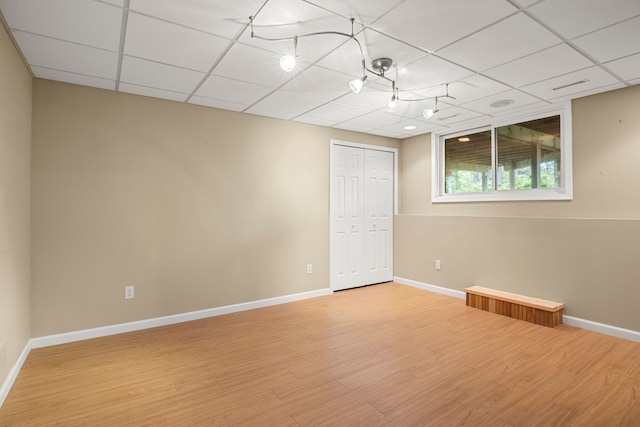 24160 Argyle St, Novi, MI 48374 - empty room with a drop ceiling, wood finished floors, and baseboards