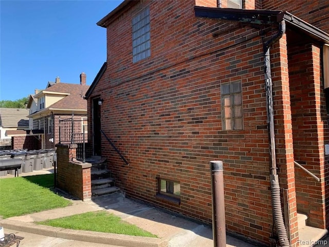view of side of home featuring brick siding