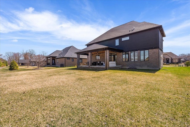 14105 Jode Park, Shelby Twp, MI 48315 - back of property featuring a yard, brick siding, a patio area, and a residential view