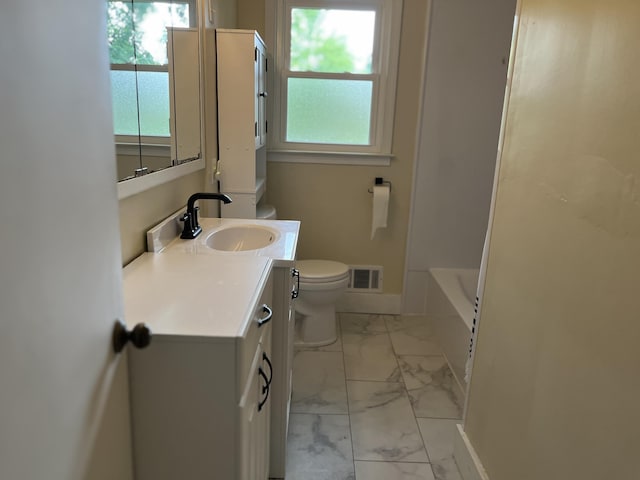 2120 Hemlock Ave, Portage, MI 49024 - full bath with marble look tiles, toilet, vanity, and healthy amount of natural light