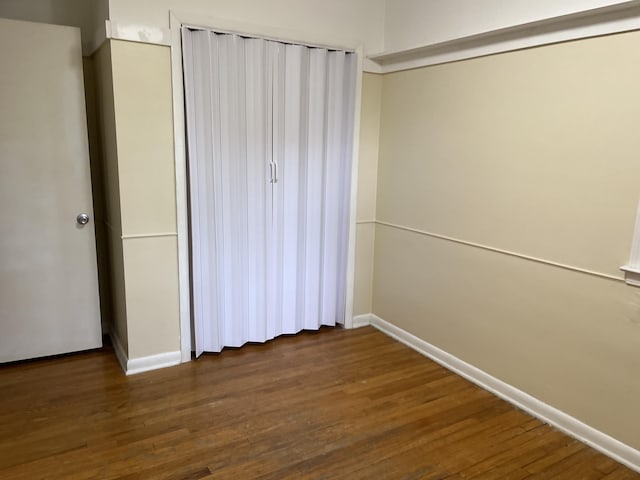 2120 Hemlock Ave, Portage, MI 49024 - unfurnished bedroom featuring baseboards, wood finished floors, and a closet