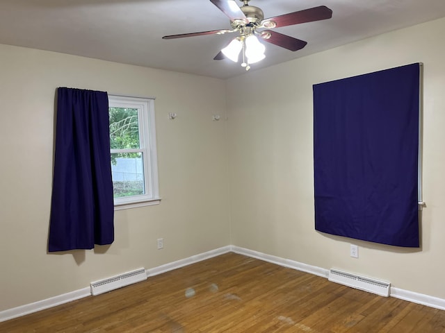 2120 Hemlock Ave, Portage, MI 49024 - empty room featuring wood finished floors, a baseboard heating unit, baseboards, and ceiling fan