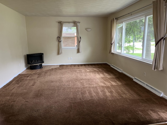 2120 Hemlock Ave, Portage, MI 49024 - unfurnished living room featuring a baseboard radiator, carpet, and baseboards