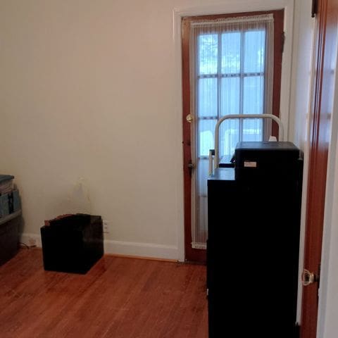 interior space featuring baseboards and wood finished floors