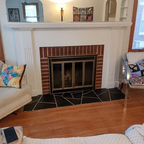 interior details featuring wood finished floors and a fireplace