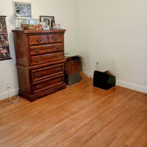 bedroom with light wood-style flooring and baseboards