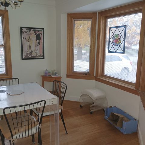 dining space with a notable chandelier, baseboards, a healthy amount of sunlight, and wood finished floors