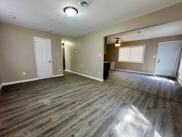 spare room with baseboards, visible vents, wood finished floors, and a ceiling fan