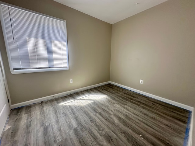 unfurnished room featuring wood finished floors and baseboards