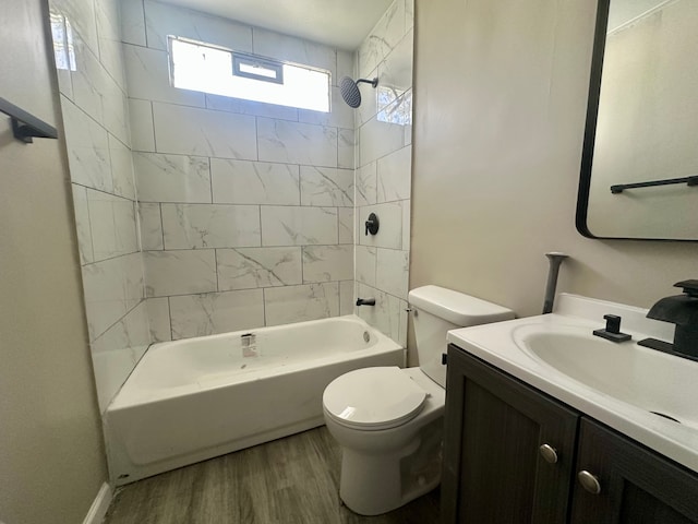 bathroom featuring wood finished floors, toilet, tub / shower combination, and vanity