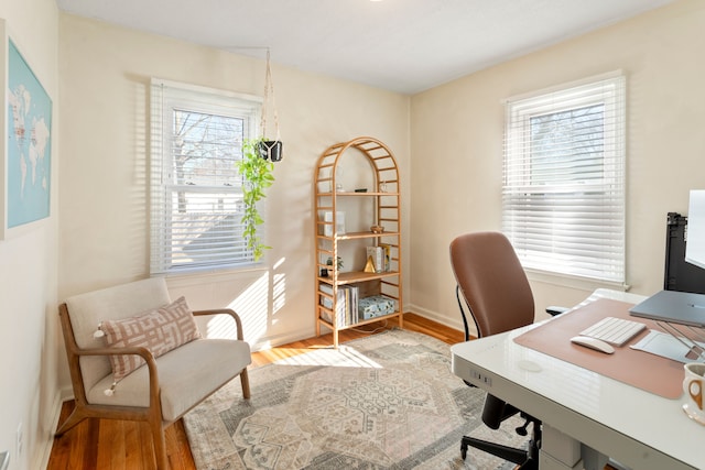 home office featuring baseboards and wood finished floors