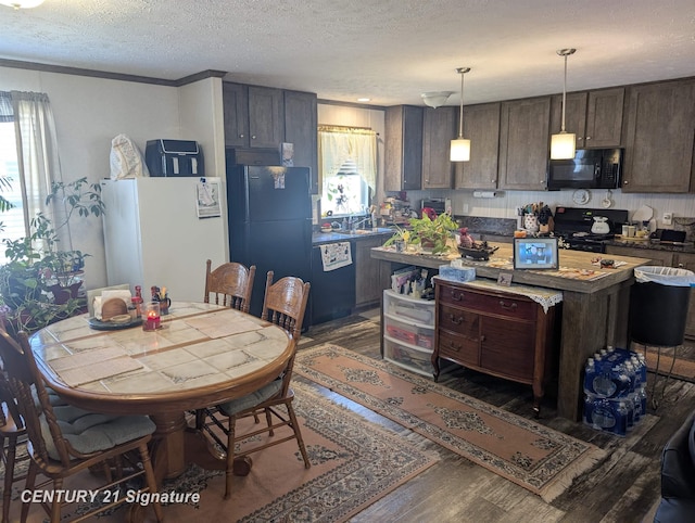 kitchen with wood finished floors, a textured ceiling, black appliances, dark brown cabinetry, and a kitchen island