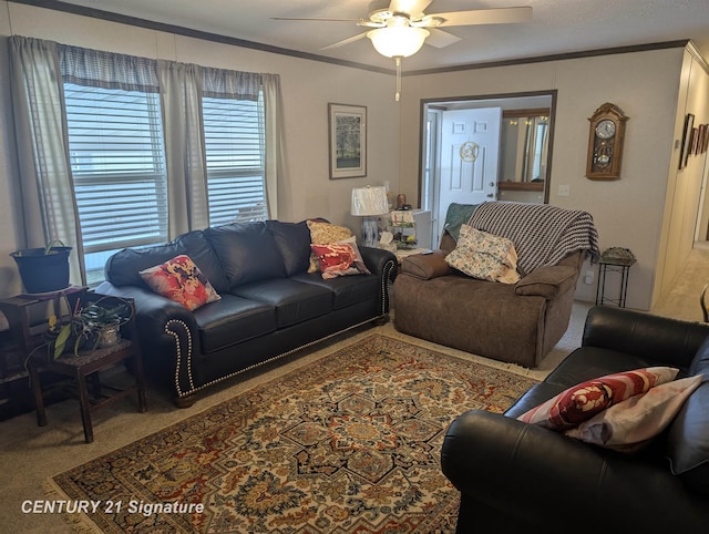 carpeted living room with a ceiling fan and crown molding
