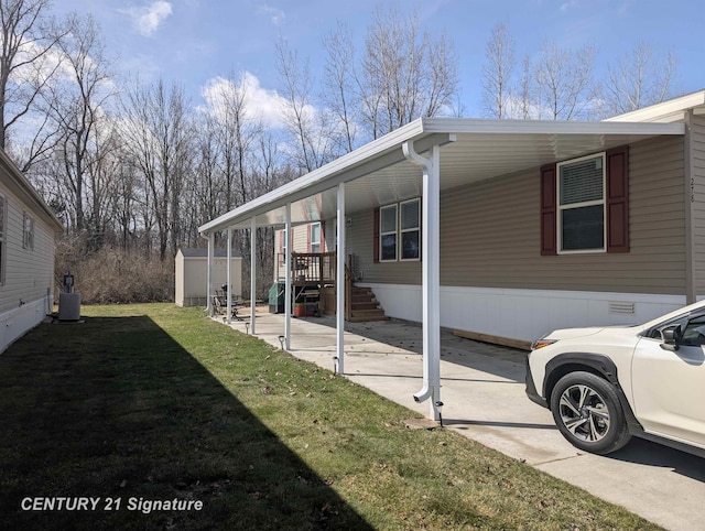 view of side of home with a shed, a carport, an outbuilding, a yard, and cooling unit