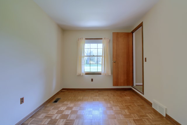 unfurnished room featuring visible vents and baseboards