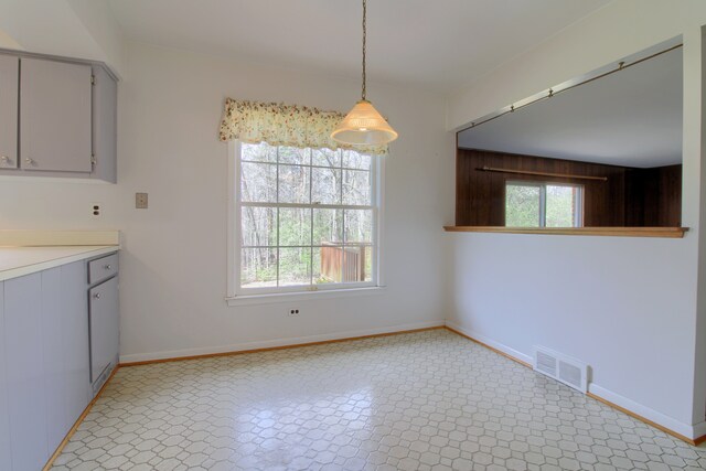 unfurnished dining area featuring visible vents and baseboards