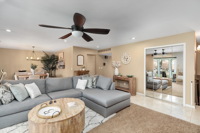 living area featuring ceiling fan with notable chandelier, light tile patterned flooring, light carpet, visible vents, and recessed lighting
