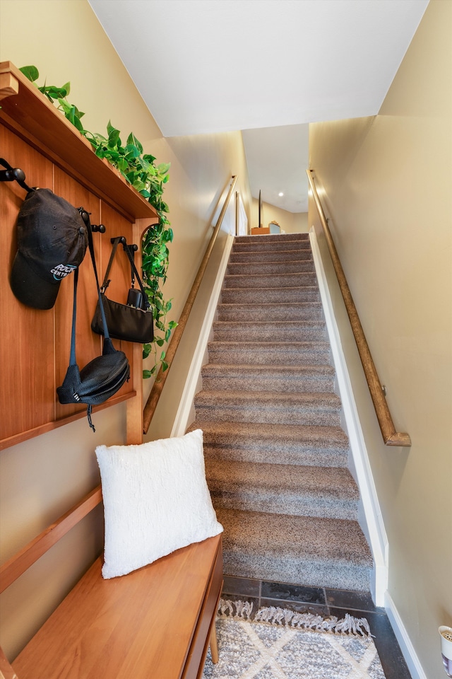 staircase featuring baseboards