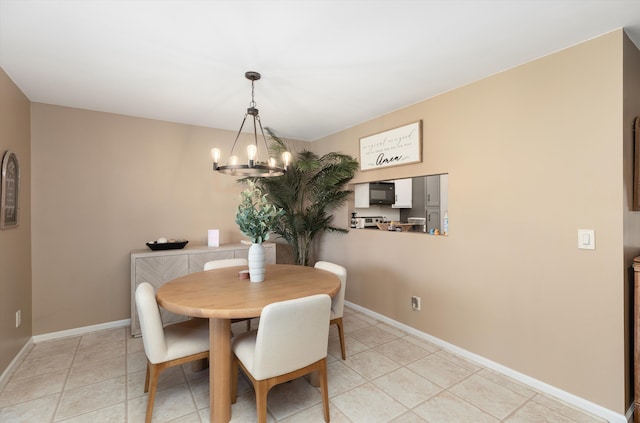 dining space with baseboards, a notable chandelier, and light tile patterned floors