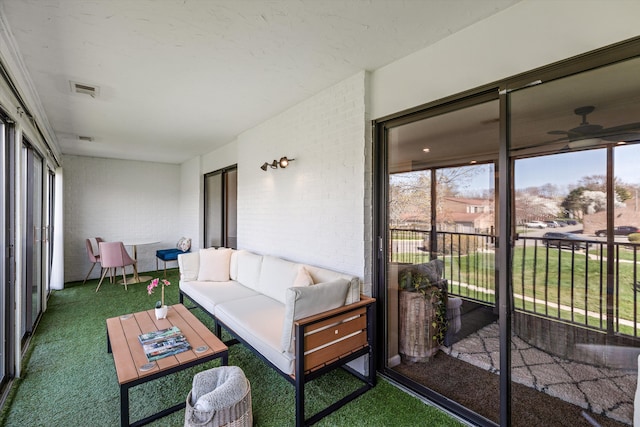 sunroom / solarium featuring an outdoor living space, ceiling fan, and visible vents