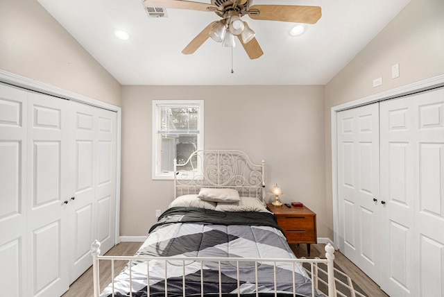bedroom featuring visible vents, baseboards, lofted ceiling, light wood-style floors, and recessed lighting