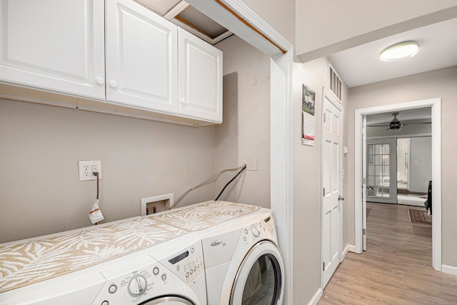 laundry room featuring baseboards, ceiling fan, cabinet space, washing machine and clothes dryer, and light wood-style flooring