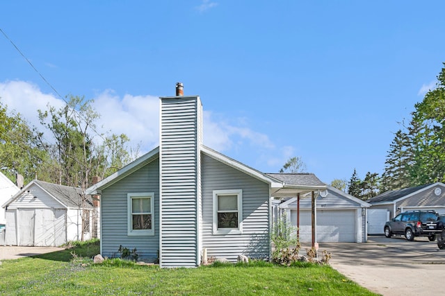 view of front of property featuring a garage, a front yard, and a chimney