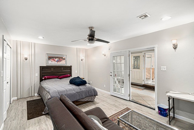 bedroom featuring a ceiling fan, baseboards, visible vents, and light wood finished floors