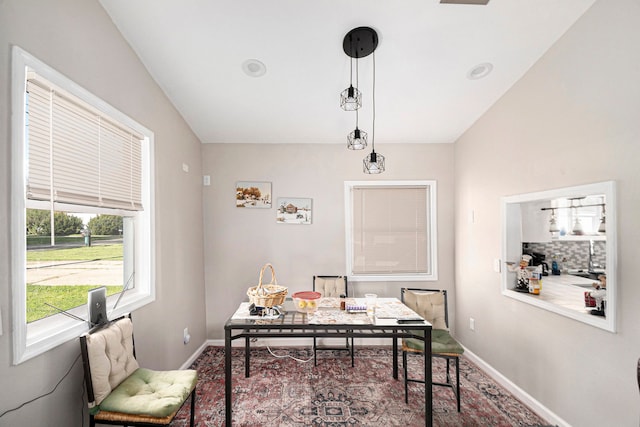 office space featuring baseboards and vaulted ceiling