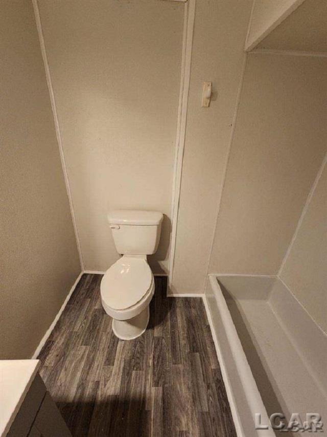 full bath with wood finished floors, vanity, and toilet