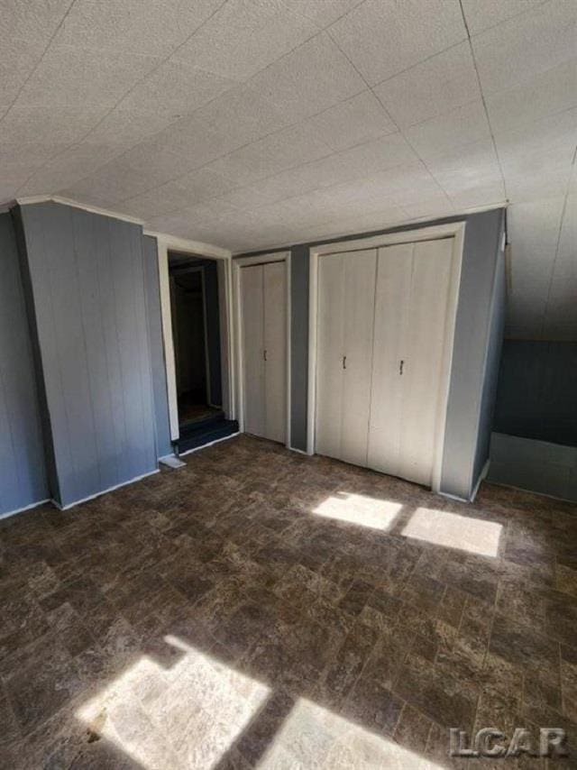 unfurnished bedroom with multiple closets
