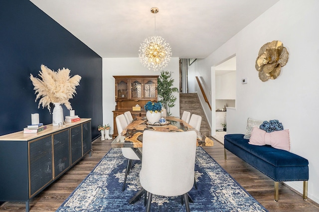 dining area featuring baseboards, dark wood-style floors, an inviting chandelier, and stairway