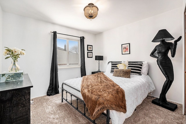 carpeted bedroom featuring baseboards
