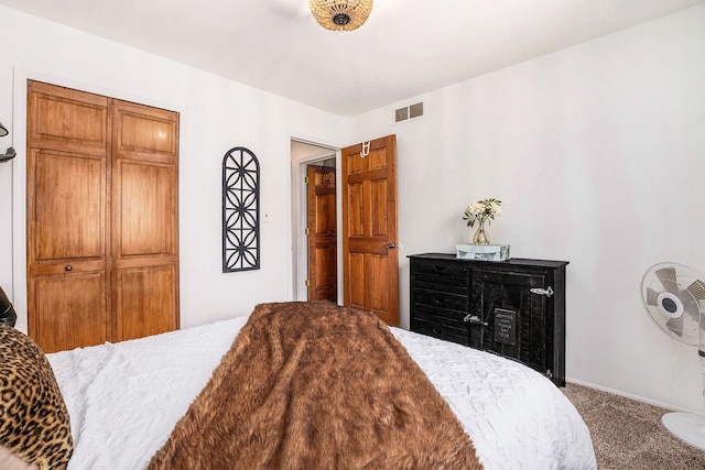 carpeted bedroom featuring baseboards and visible vents
