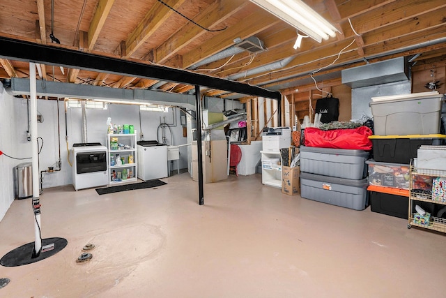 below grade area with washing machine and dryer, heating unit, and a sink