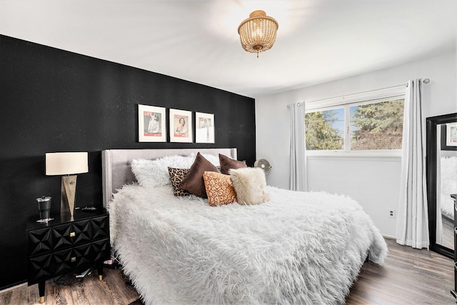 bedroom featuring baseboards and wood finished floors