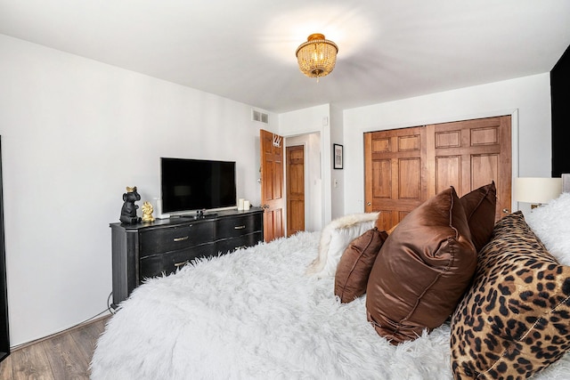 bedroom with wood finished floors and visible vents