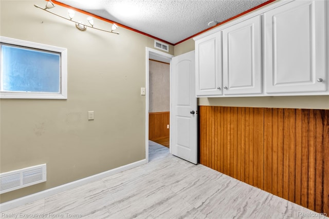 1822 Elizabeth Ter, Madison Heights, MI 48071 - spare room with a textured ceiling and a wainscoted wall