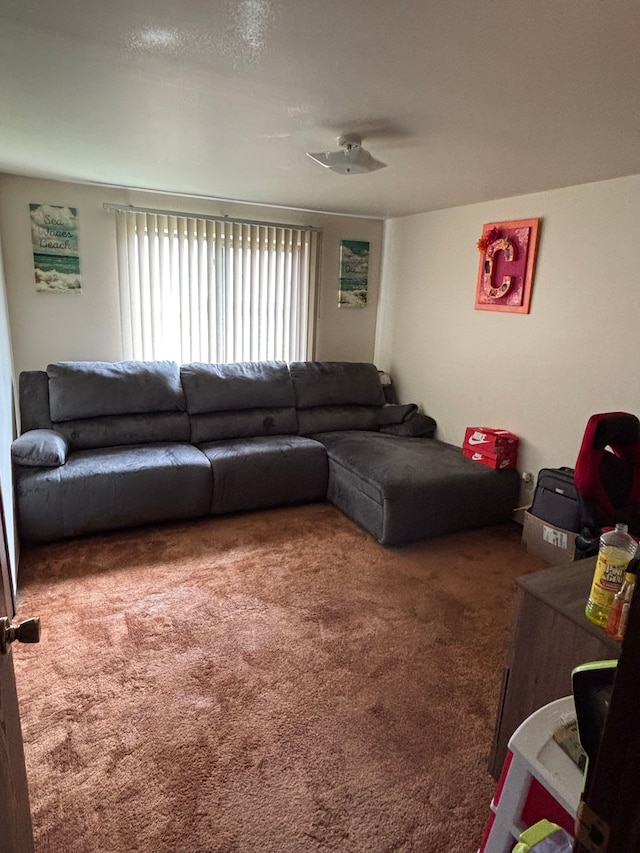 living room with a ceiling fan and carpet flooring
