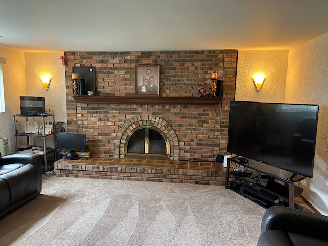 living area featuring carpet floors, a textured wall, and a brick fireplace