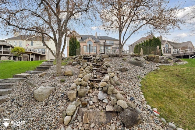 view of yard featuring fence and a residential view