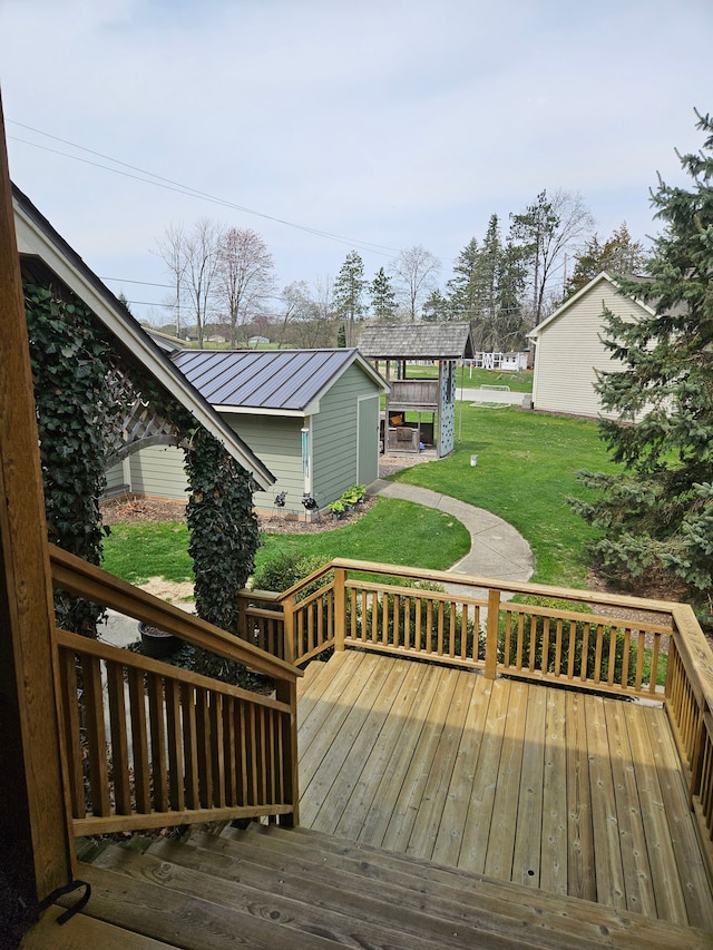 wooden deck featuring a lawn