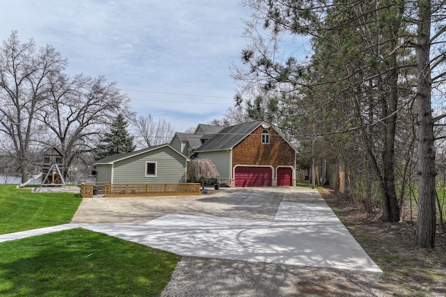 view of front of house featuring concrete driveway and a front lawn