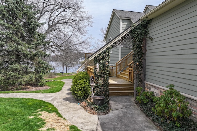 view of side of home featuring roof with shingles