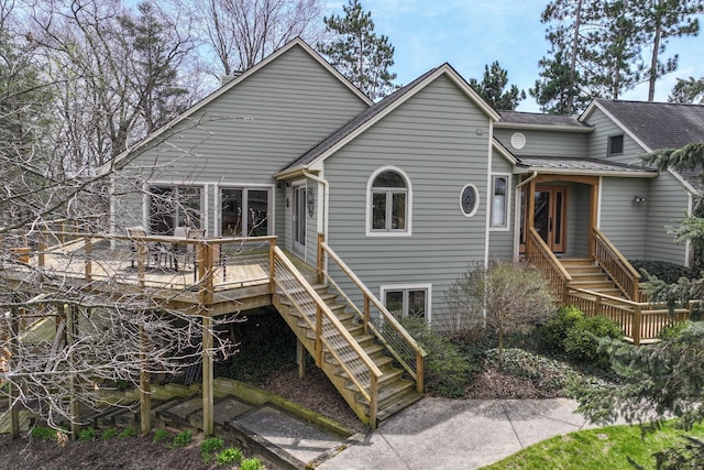 back of house with a wooden deck and stairs